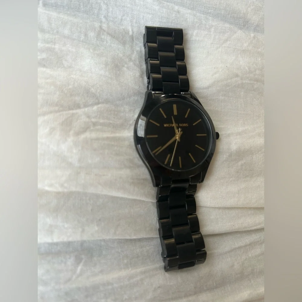 Michael Kors Black and Gold Watch It needs a battery replacement.